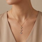 Collier en or jaune 18k pendentif trois papillons sertis de pierres - bijou porté par une mannequin