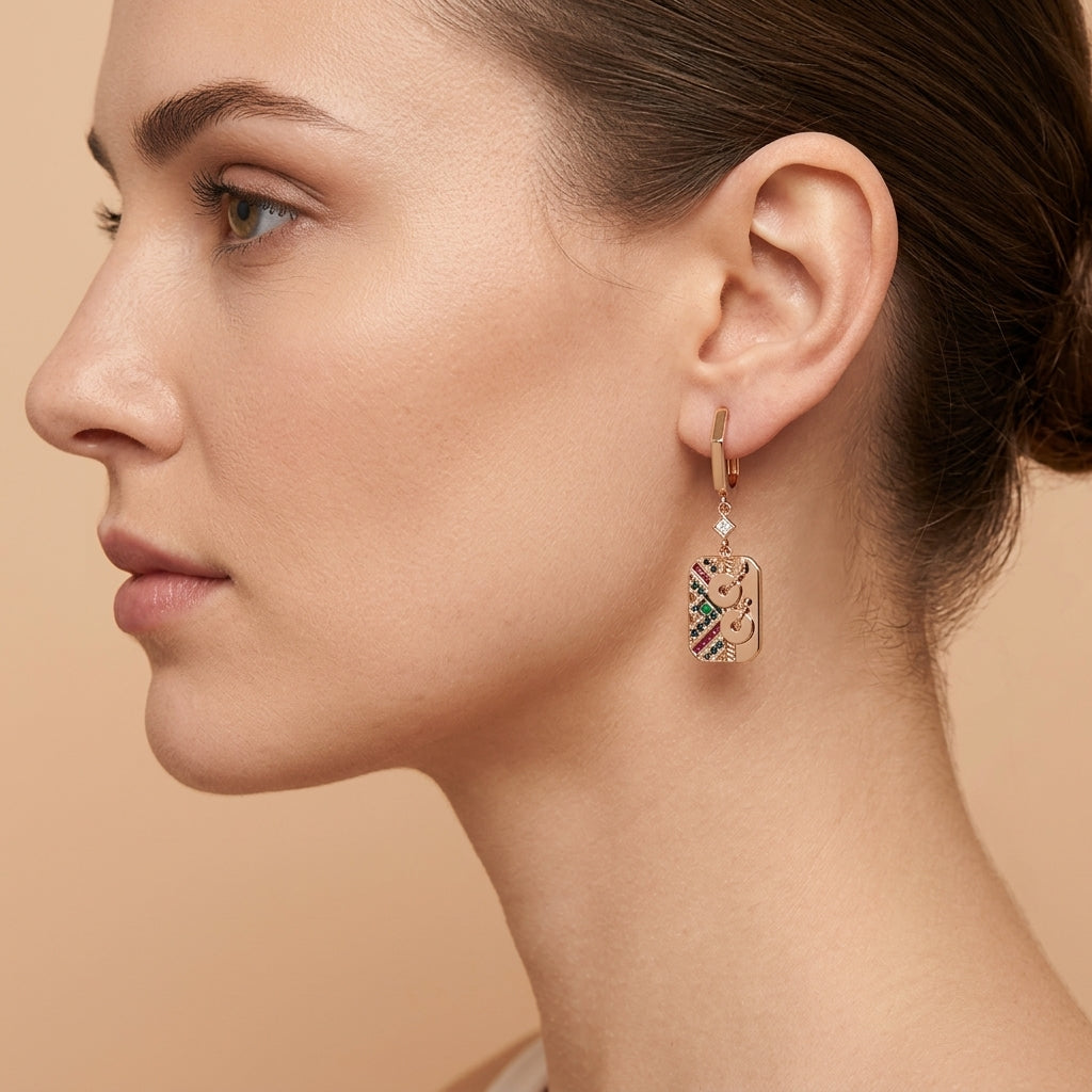 Boucles d'oreilles pendantes en or rose 18k plaques serties de pierres multicolores - bijou porté par une mannequin