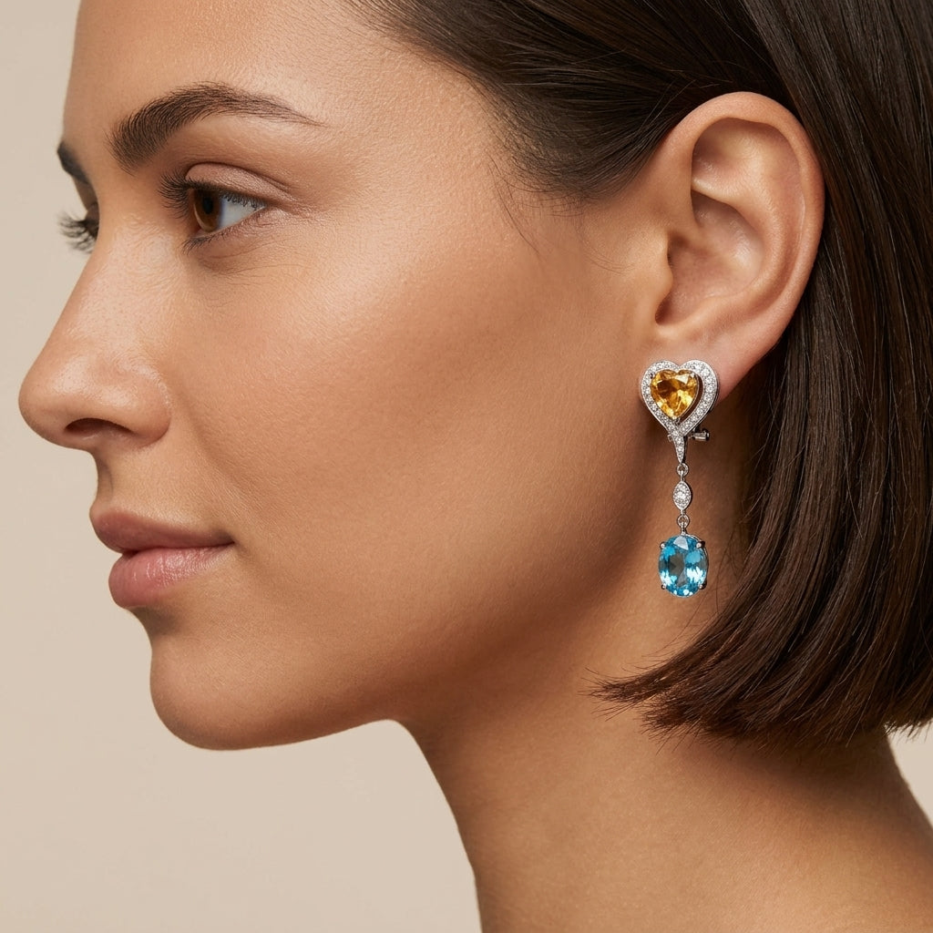 Boucles d'oreilles pendantes en or blanc 18k pierres jaunes et topazes bleues, serties - bijou porté par une mannequin