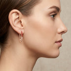 Boucles d'oreilles pendantes en or rose 18k serties, émail rouge - bijou porté par une mannequin