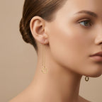 Boucles d'oreilles pendantes chaînettes trèfles en or jaune 18k - bijou porté par une mannequin