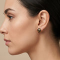 Boucles d'oreilles puces rondes en or jaune 18k motif léopard émaillé - bijou porté par une mannequin
