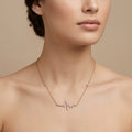 Collier en or rose 18k pendentif battement de cœur serti de pierres - bijou porté par une mannequin