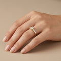 Bague solitaire en or jaune 18k épaulée de pierres - bijou porté par une mannequin