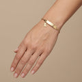 Bracelet gourmette bébé en or jaune 18k plaque à graver - bijou porté par une mannequin