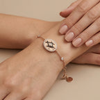 Bracelet chaîne en or rose 18k médaille ovale sertie - bijou porté par une mannequin