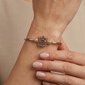 Bracelet jonc boulhya en or rose 18k rosace sertie de pierres - bijou porté par une mannequin