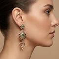 Boucles d'oreilles pendantes beldi rosaces en or rose 18k serties, croissants et pierres vertes - bijou porté par une mannequin