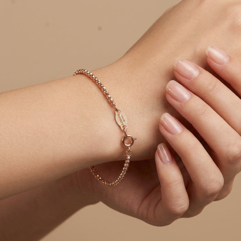 Bracelet boules facettées en or rose 18k - bijou porté par une mannequin