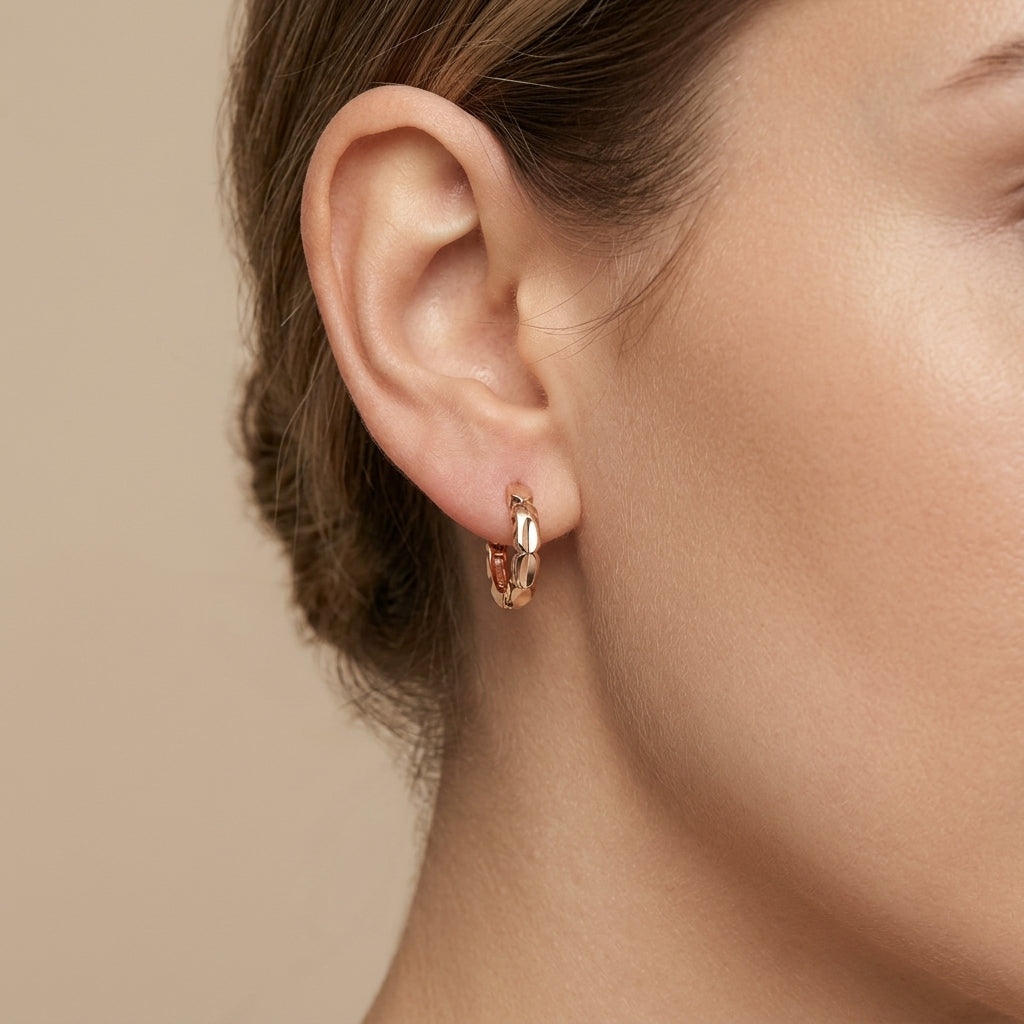 Boucles d'oreilles mini créoles ciselées en or rose 18k - bijou porté par une mannequin