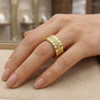 Bague en or jaune 18k double anneau serti de pierres - bijou porté par une mannequin