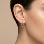 Boucles d'oreilles mini créoles lisses en or rose 18k - bijou porté par une mannequin